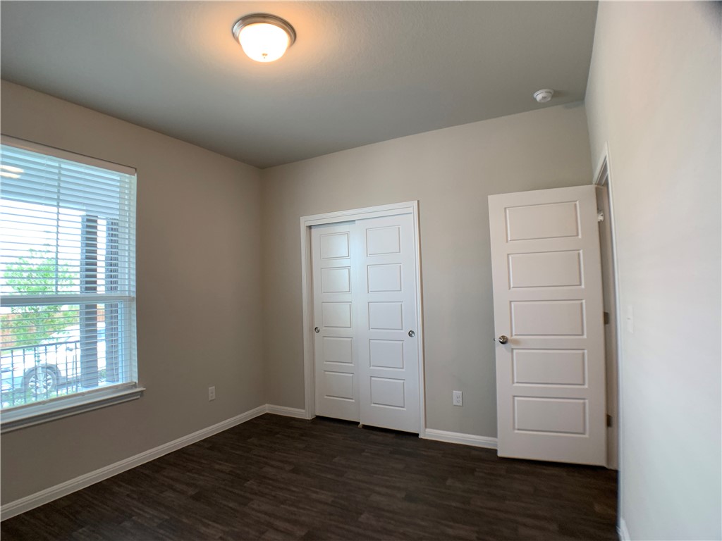 237 Michaelis Drive Leander, TX 78641 - Photo 15 of 23 an empty room with wooden floor and windows