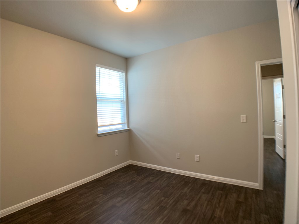 237 Michaelis Drive Leander, TX 78641 - Photo 16 of 23 a view of an empty room with wooden floor and a window