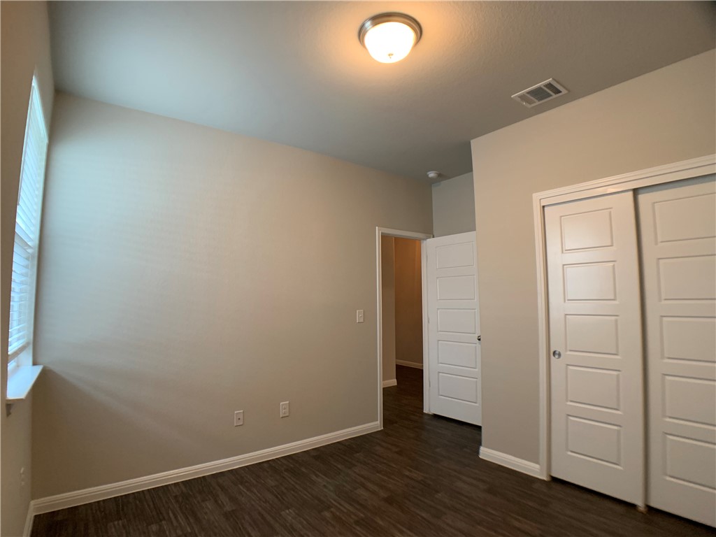 237 Michaelis Drive Leander, TX 78641 - Photo 19 of 23 an empty room with wooden floor and closet