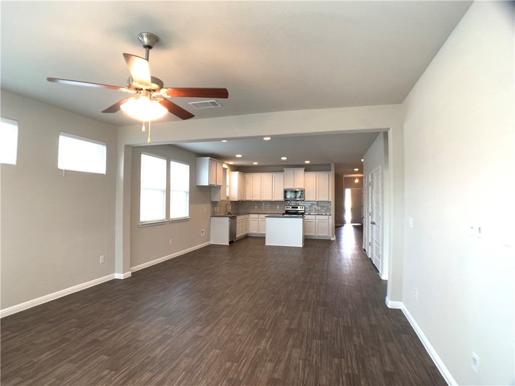 237 Michaelis Drive Leander, TX 78641 - Photo 9 of 23 a view of empty room with wooden floor and fan