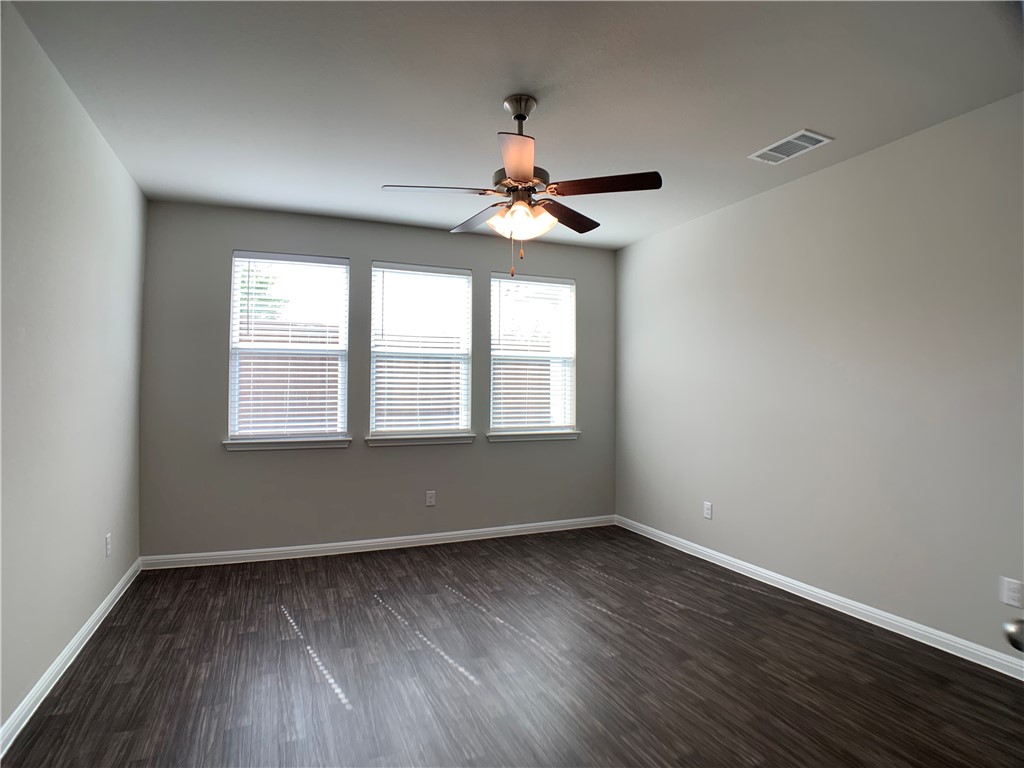 237 Michaelis Drive Leander, TX 78641 - Photo 10 of 23 wooden floor in an empty room with a window