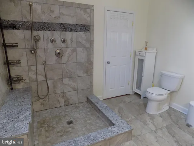 a white toilet sitting next to a bathroom sink