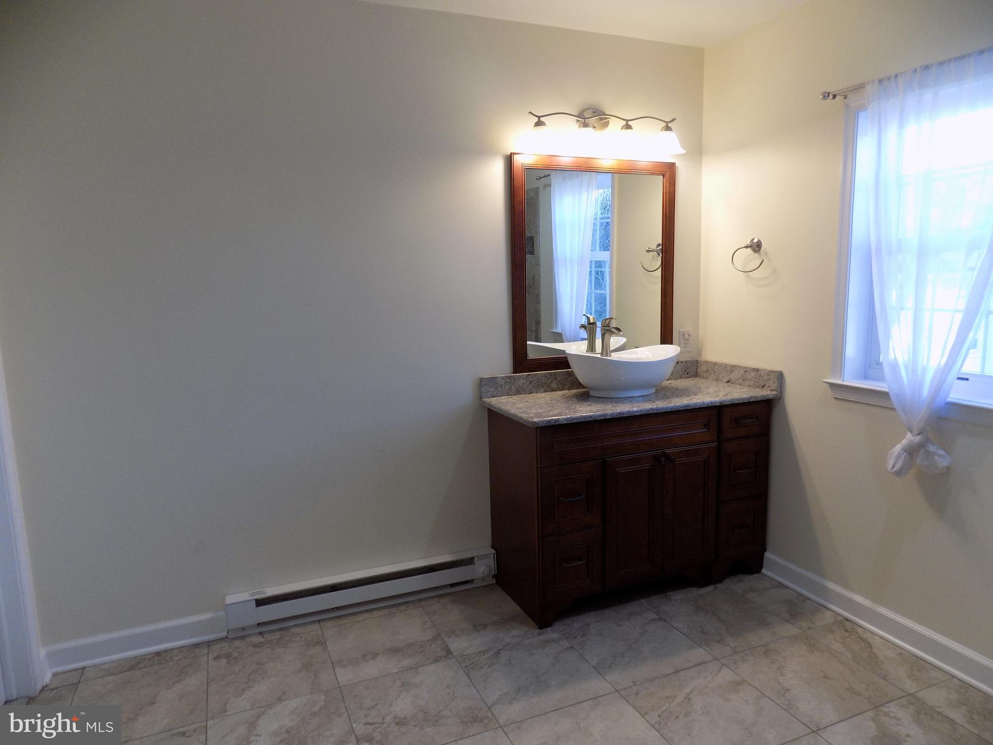 53 Sunset Avenue, Unit 3 Chalfont, PA 18914 - Photo 14 of 20 a bathroom with a sink and a mirror