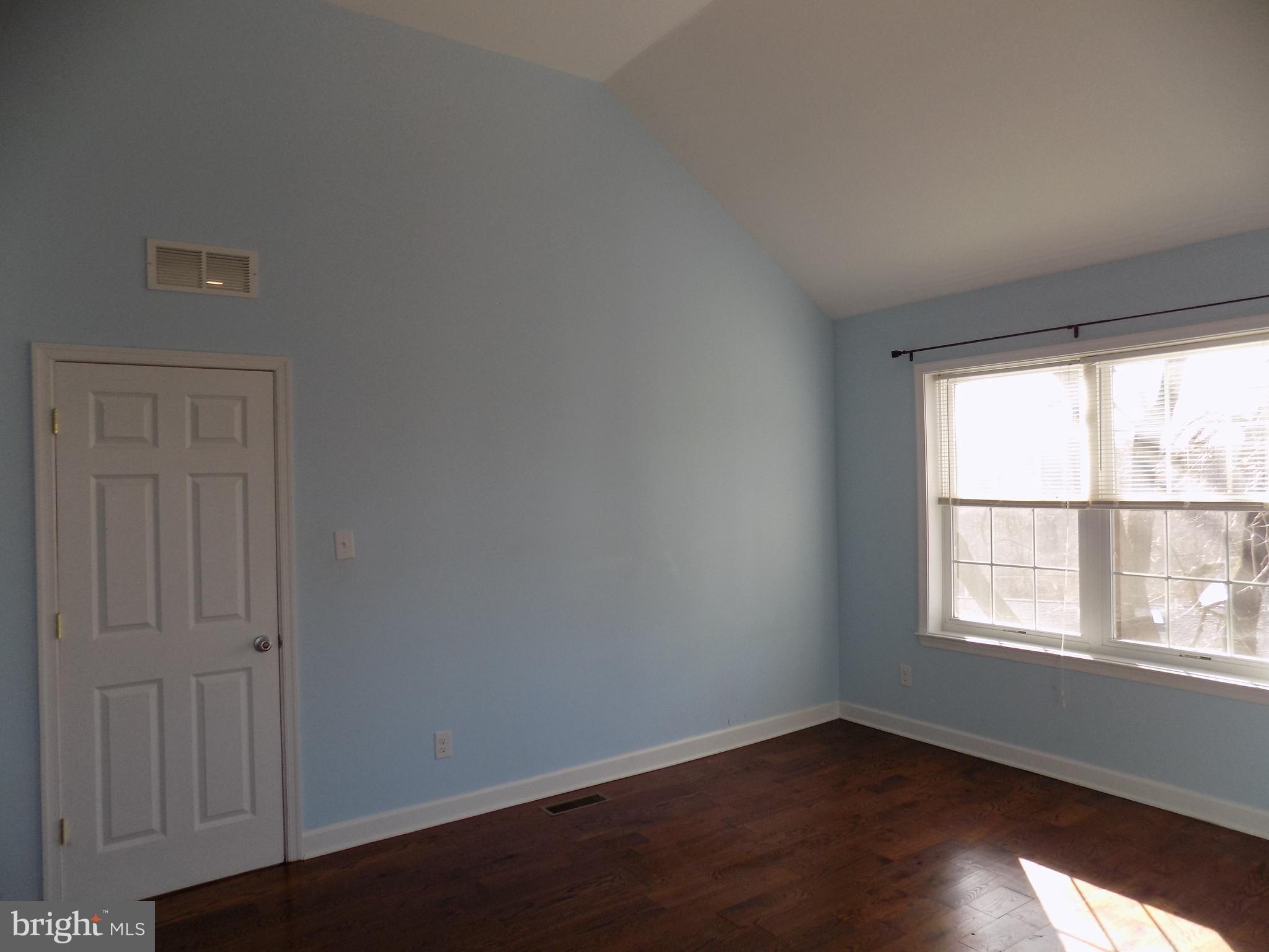 53 Sunset Avenue, Unit 3 Chalfont, PA 18914 - Photo 17 of 20 an empty room with wooden floor and windows