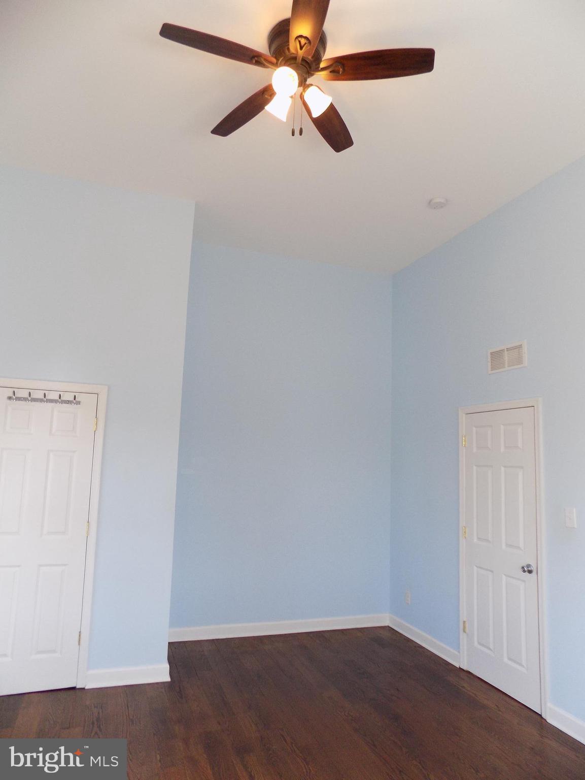 53 Sunset Avenue, Unit 3 Chalfont, PA 18914 - Photo 18 of 20 an empty room with a ceiling fan and a window