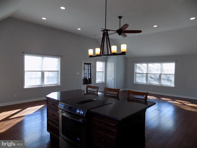 a kitchen with a table chairs and wooden floor