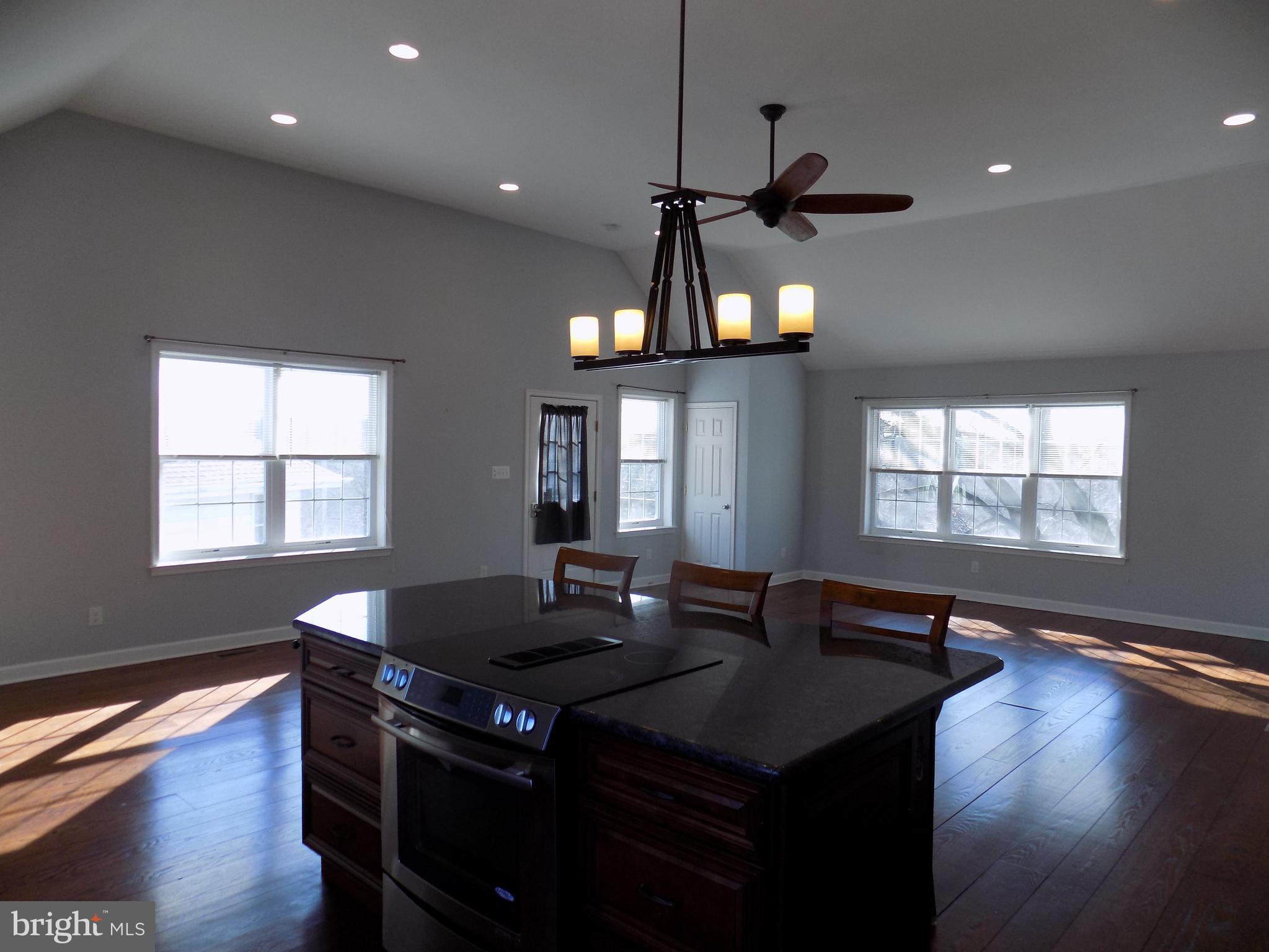 53 Sunset Avenue, Unit 3 Chalfont, PA 18914 - Photo 3 of 20 a kitchen with a table chairs and wooden floor