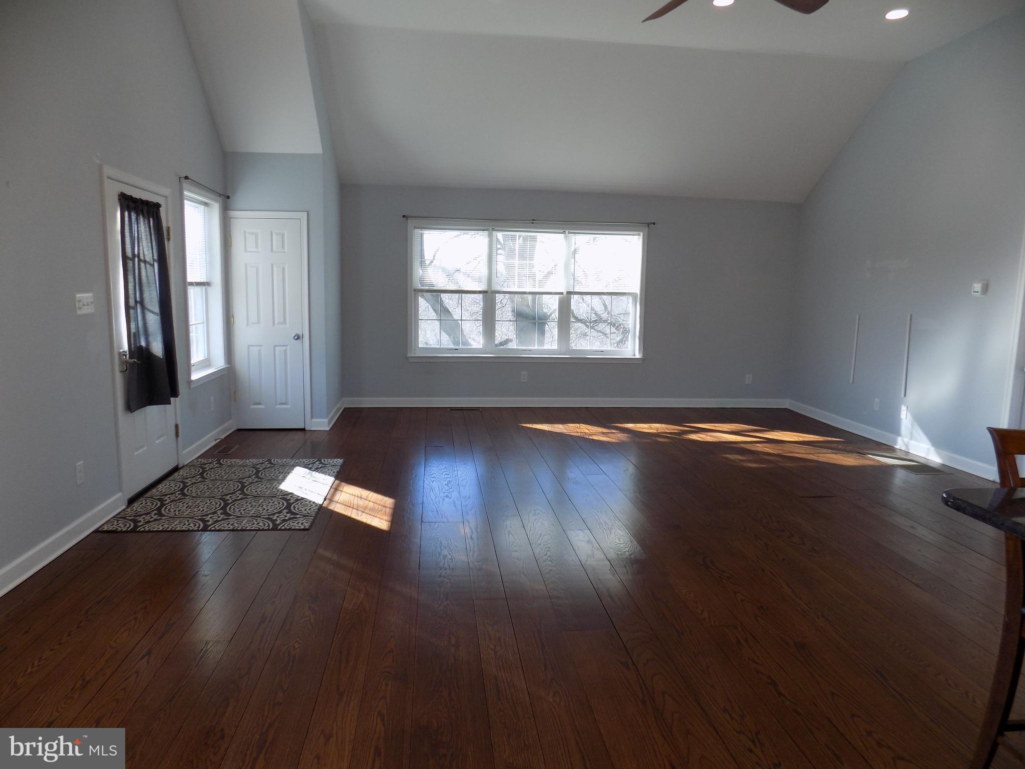 53 Sunset Avenue, Unit 3 Chalfont, PA 18914 - Photo 10 of 20 an empty room with wooden floor and windows