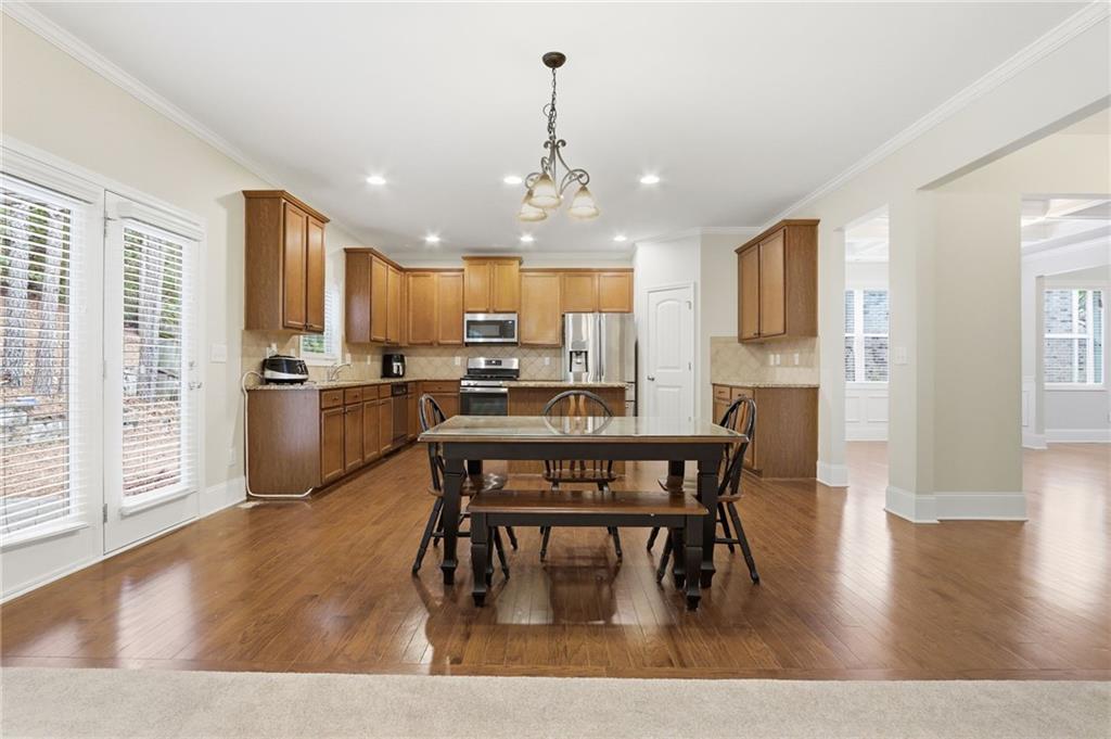 1515 Riva Ridge Suwanee, GA 30024 - Photo 12 of 35 a view of kitchen with refrigerator a microwave and wooden floor