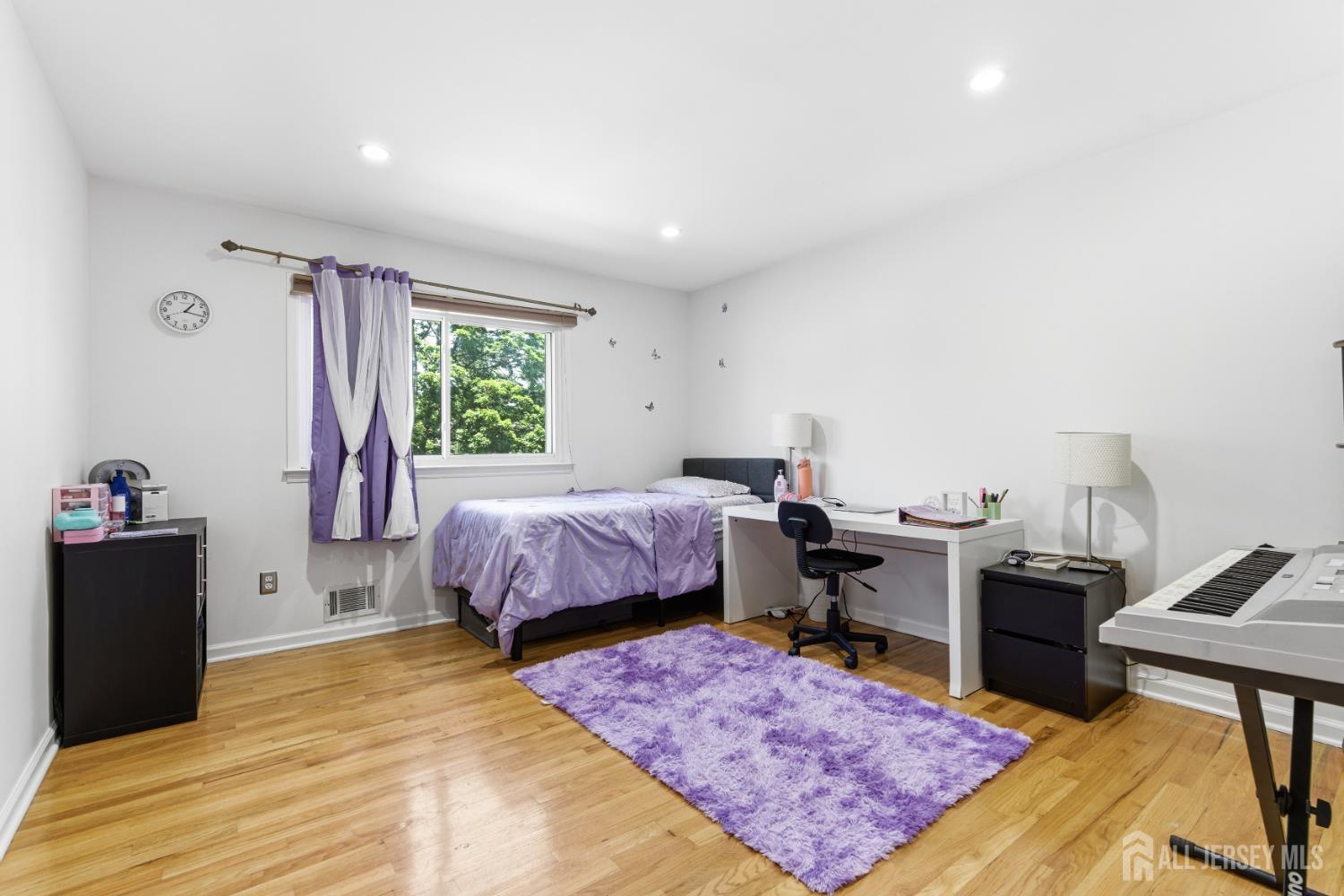 213 Normandy Road Edison, NJ 08820 - Photo 30 of 45 a bed room with a bed and a table