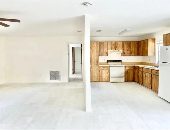a large white kitchen with white cabinets