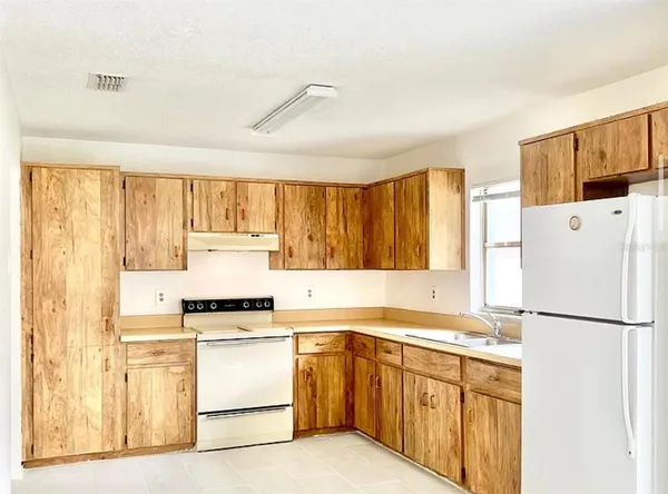 a kitchen with a refrigerator a stove a sink and a refrigerator