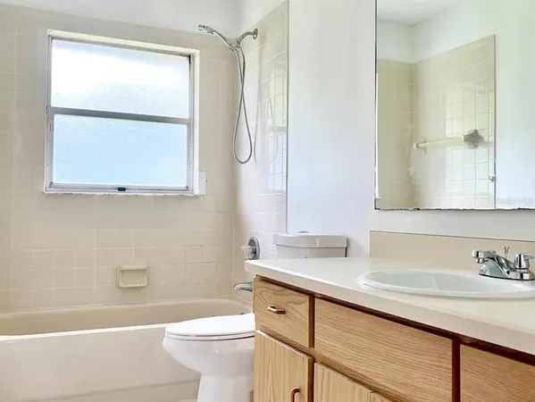 a bathroom with a sink a toilet and a bathtub