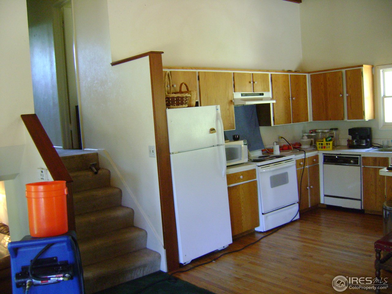2980 Sugarloaf Road Boulder, CO 80302 - Photo 4 of 15 a kitchen with a refrigerator a sink and wooden floors