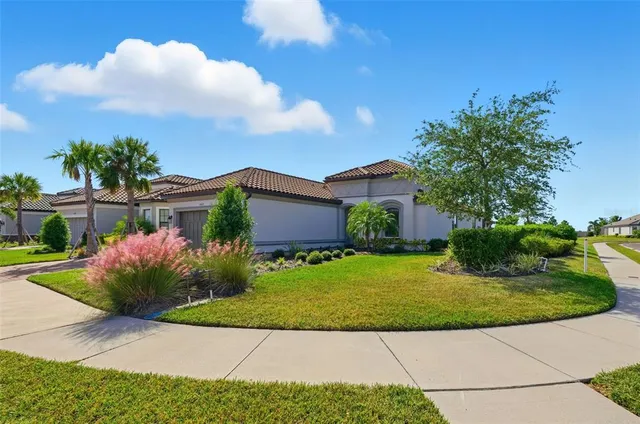 a front view of a house with garden