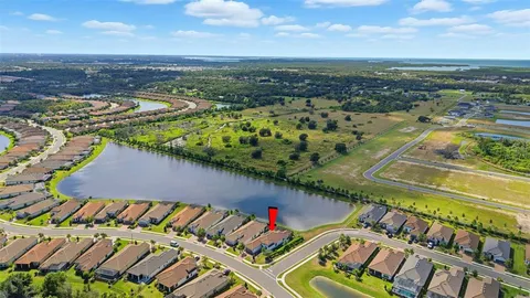 an aerial view of a house with a lake view