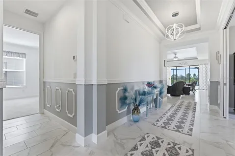 a view of a hallway to dining room and wooden floor