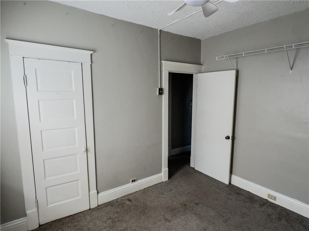 870 Chestnut Street Coplay, PA 18037 - Photo 14 of 24 Well-lit room offers versatile space for rest or productivity, featuring plush carpeting and a convenient closet.