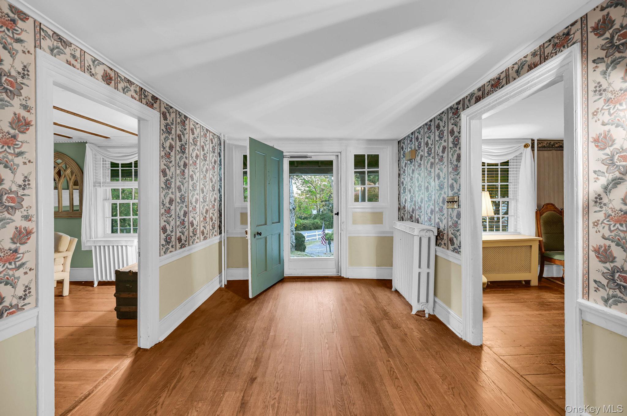 33 Ryder Road Ossining, NY 10562 - Photo 2 of 48 Entryway with wallpapered walls, healthy amount of natural light, light wood-type flooring, and radiator heating unit