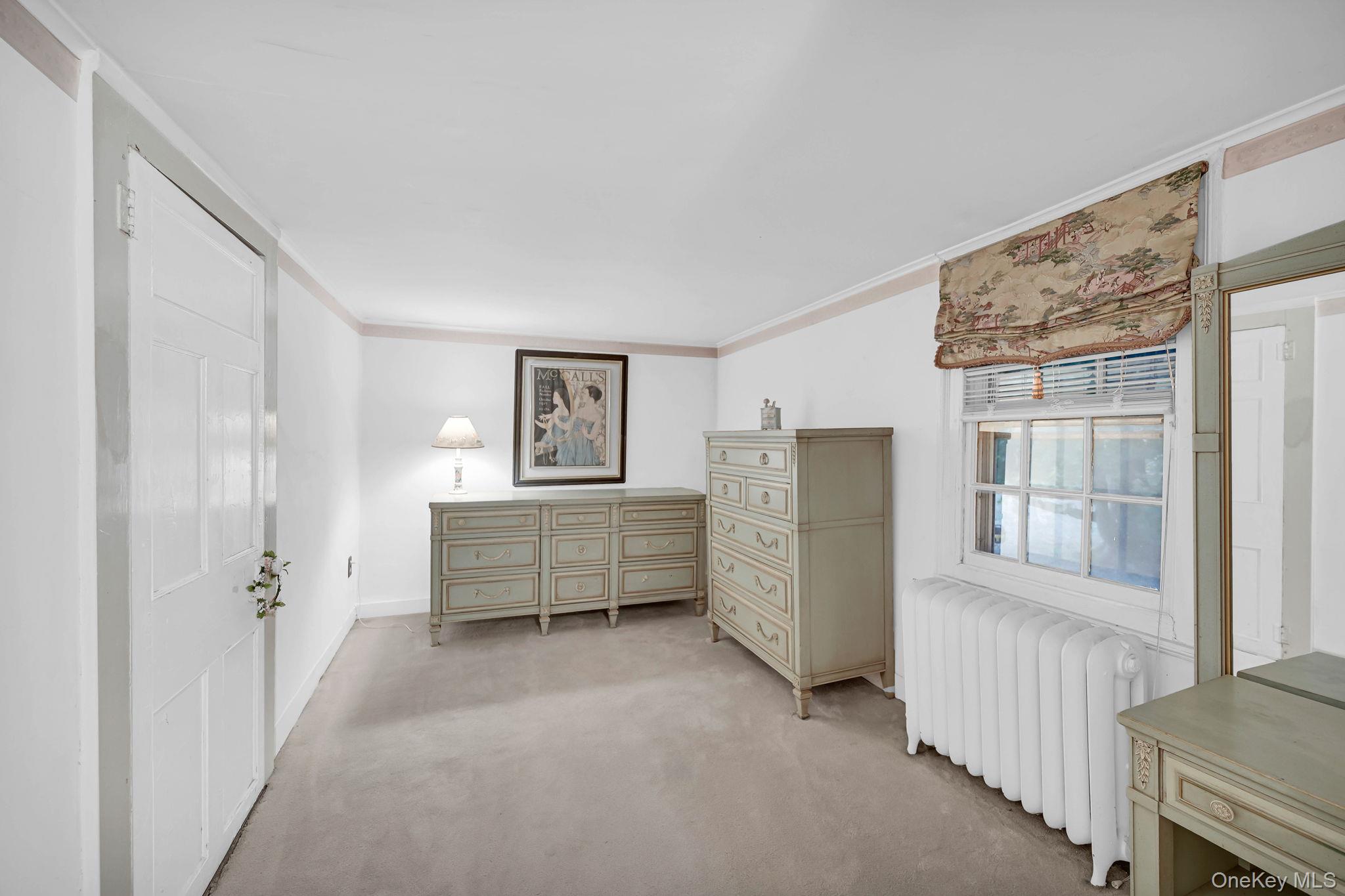 33 Ryder Road Ossining, NY 10562 - Photo 22 of 48 Carpeted bedroom featuring radiator heating unit and ornamental molding