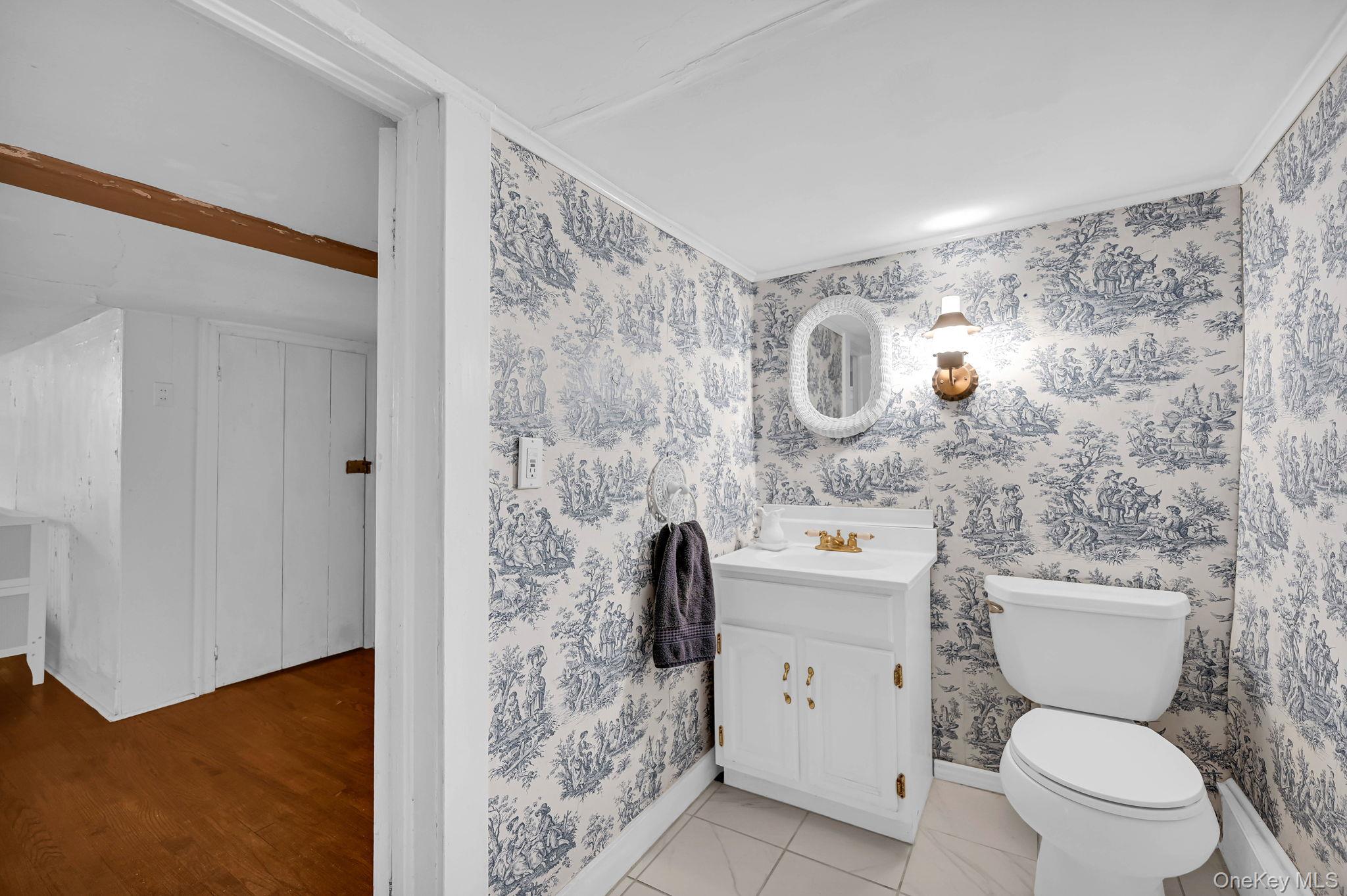 33 Ryder Road Ossining, NY 10562 - Photo 27 of 48 Half bath featuring vanity, light tile patterned flooring, and ornamental molding