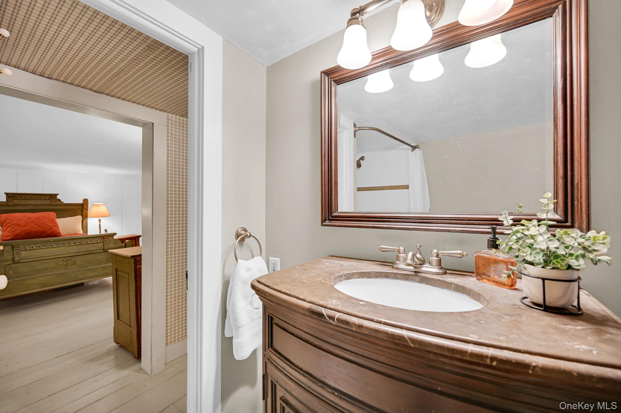 33 Ryder Road Ossining, NY 10562 - Photo 29 of 48 Ensuite bathroom featuring vanity, curtained shower, and wood-type flooring
