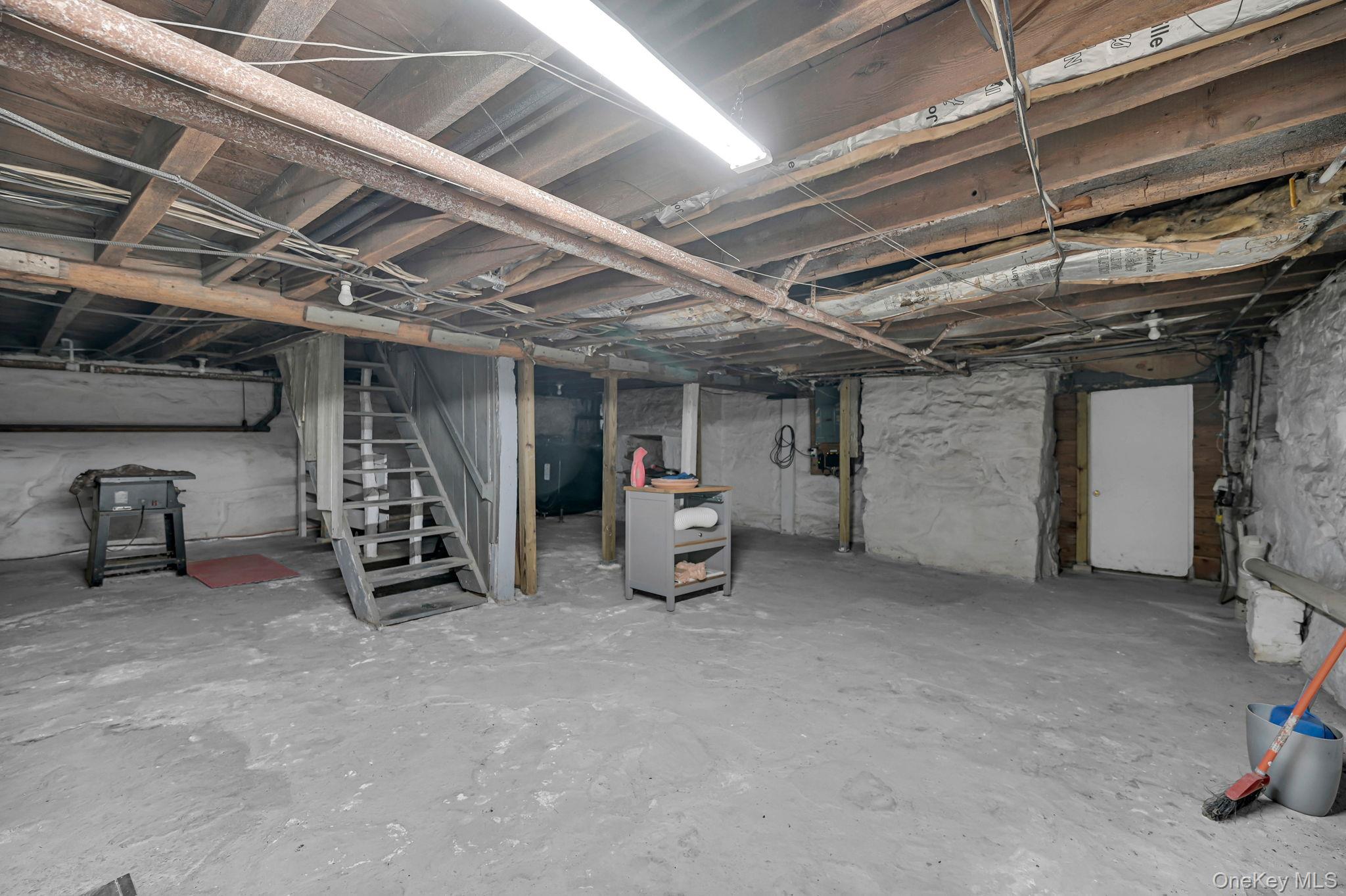 33 Ryder Road Ossining, NY 10562 - Photo 33 of 48 Unfinished basement featuring stairway and oil tank