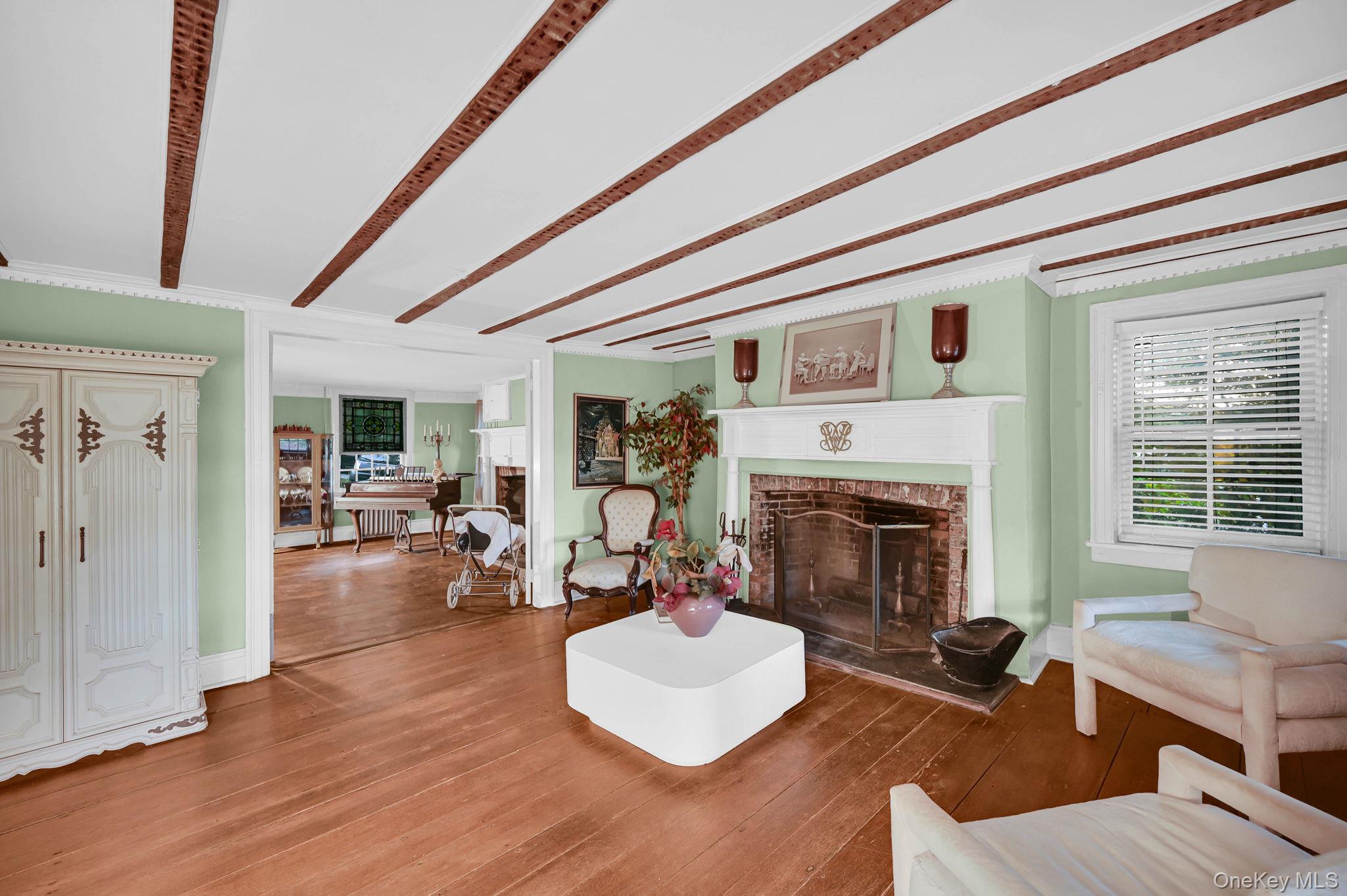33 Ryder Road Ossining, NY 10562 - Photo 4 of 48 Living room with a brick fireplace, wood finished floors, and crown molding