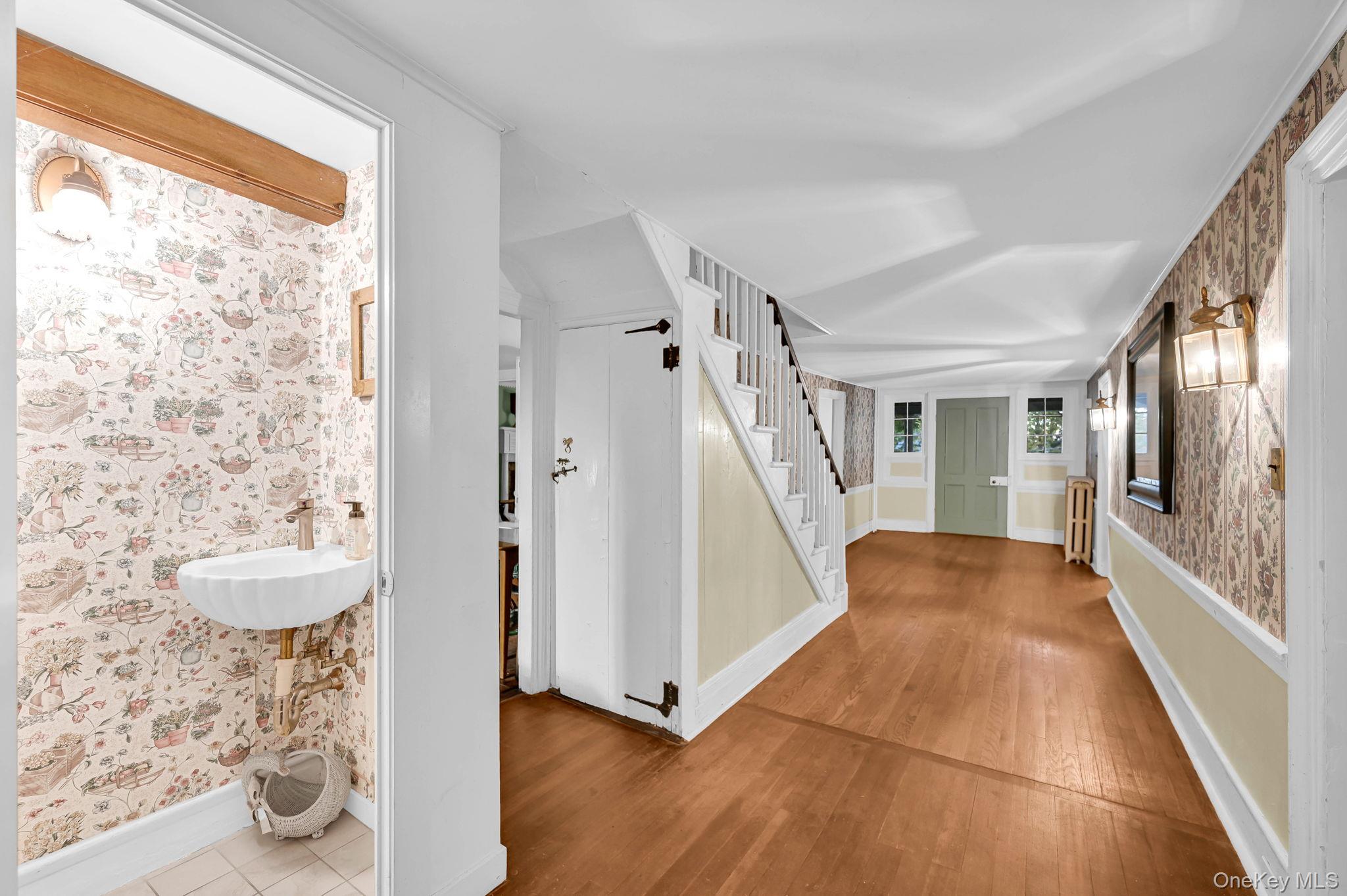 33 Ryder Road Ossining, NY 10562 - Photo 8 of 48 Foyer entrance with wallpapered walls, wood finished floors, and stairway