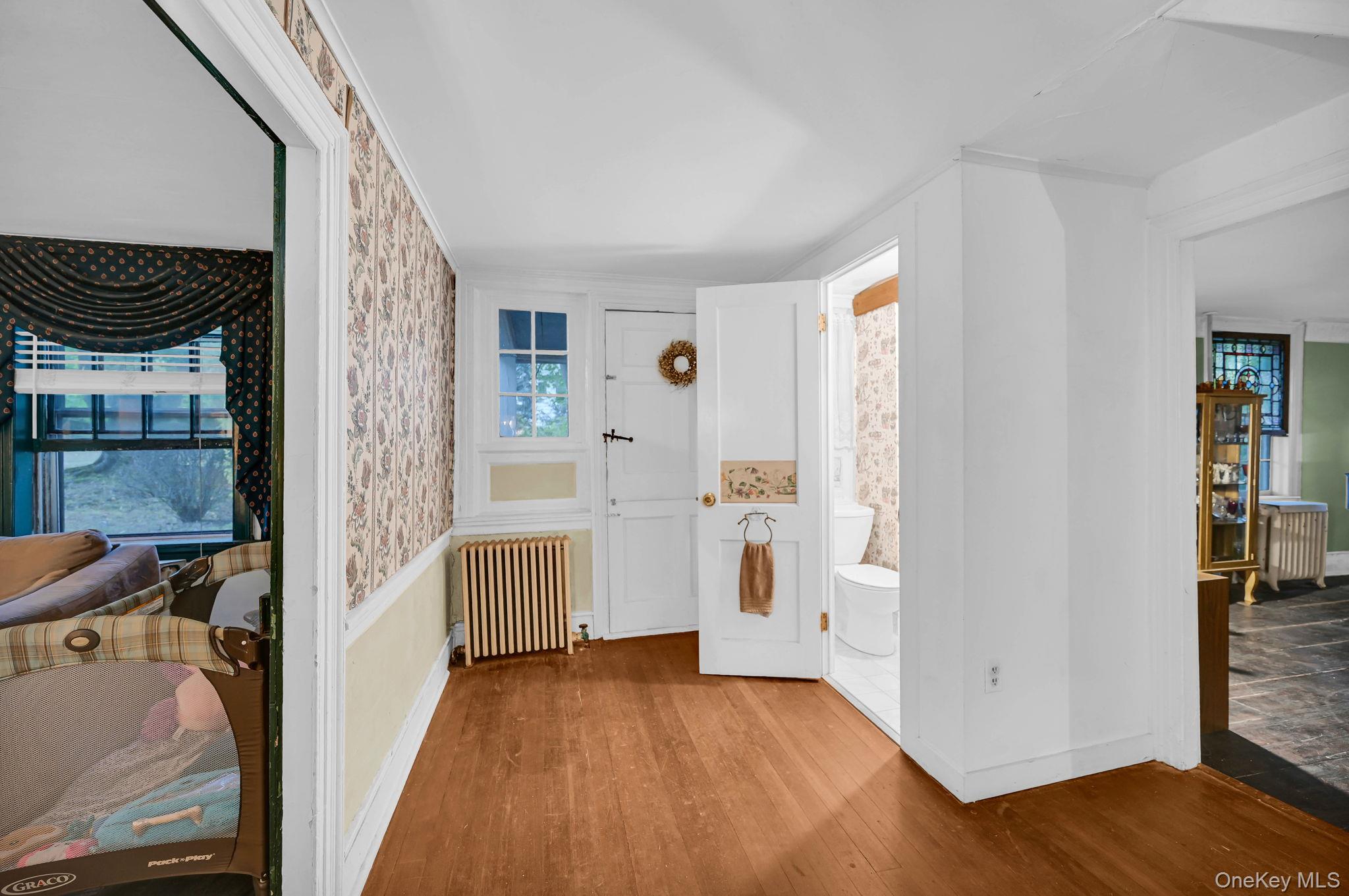 33 Ryder Road Ossining, NY 10562 - Photo 9 of 48 Entryway featuring radiator heating unit, wood finished floors, and wallpapered walls