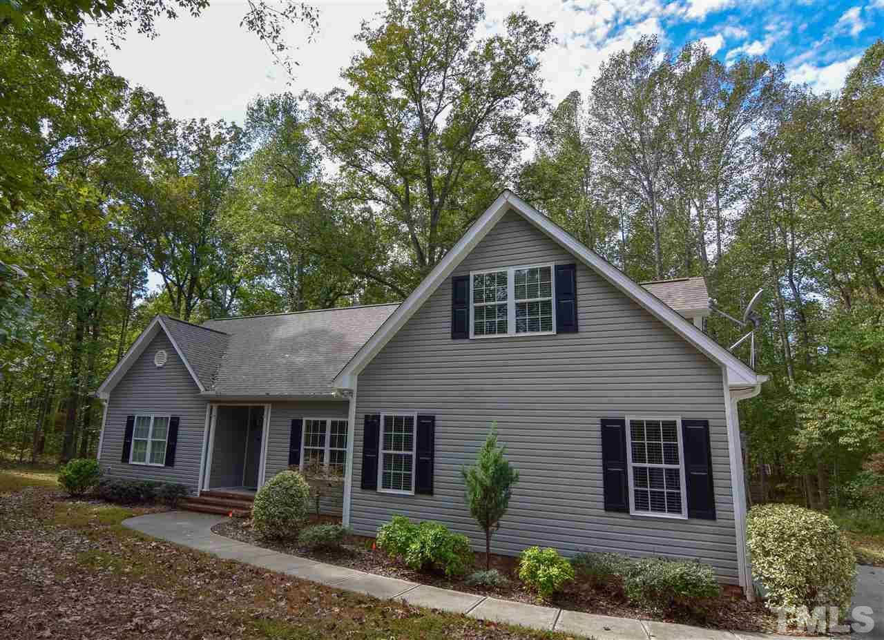 292 Ned Moore Road Timberlake, NC 27583 - Photo 1 of 25 a front view of a house with garden