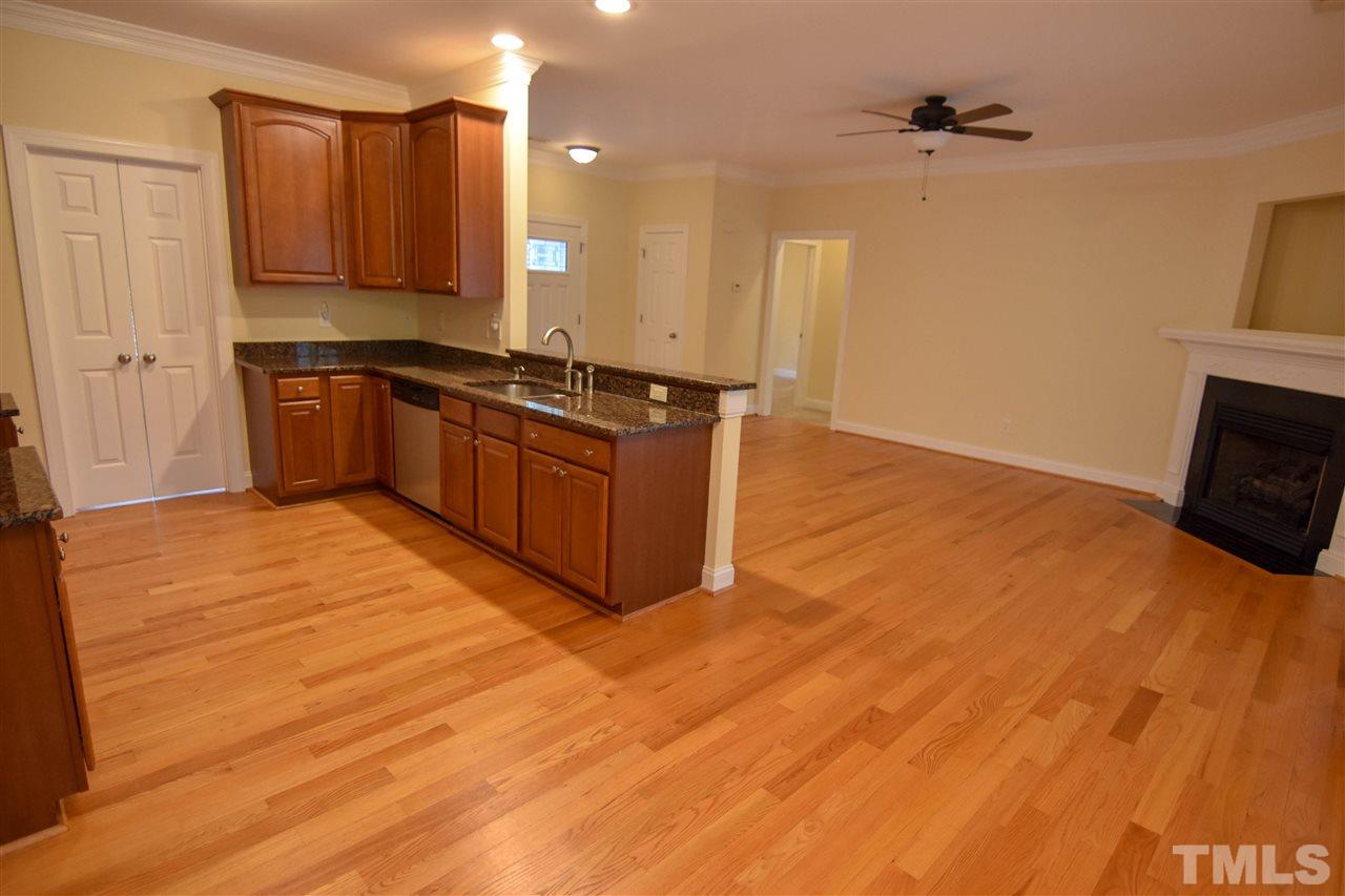 292 Ned Moore Road Timberlake, NC 27583 - Photo 2 of 25 a large kitchen with stainless steel appliances granite countertop a stove a sink and a refrigerator