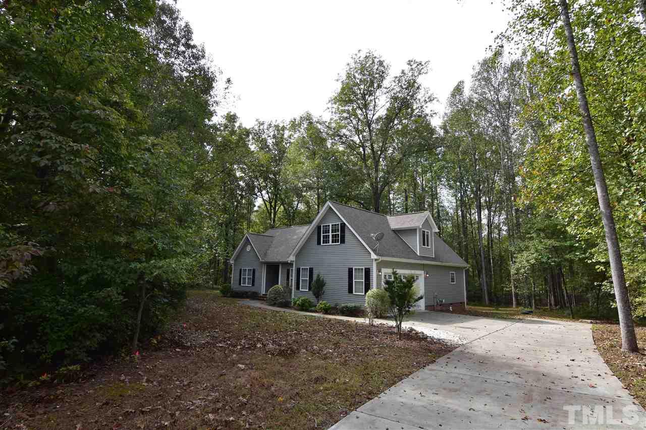 292 Ned Moore Road Timberlake, NC 27583 - Photo 12 of 25 a front view of a house with a garden