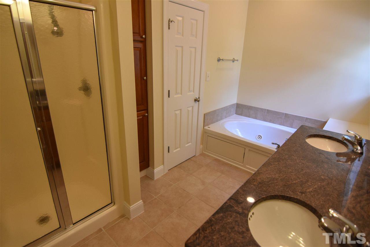 292 Ned Moore Road Timberlake, NC 27583 - Photo 14 of 25 a bathroom with a sink and mirror