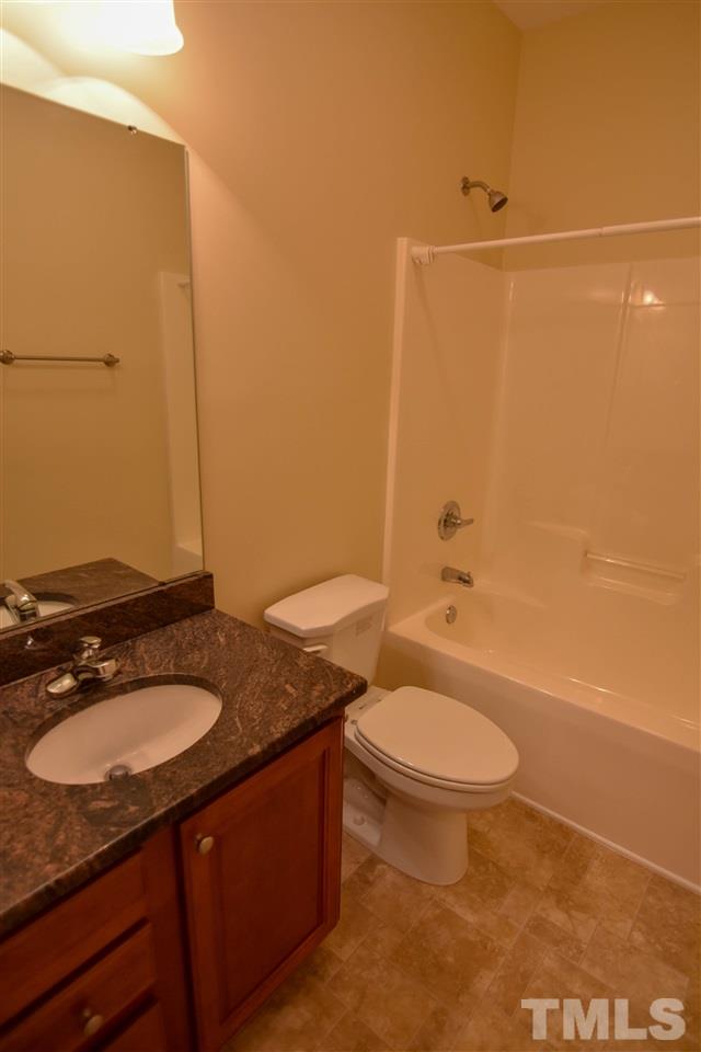 292 Ned Moore Road Timberlake, NC 27583 - Photo 18 of 25 a bathroom with a granite countertop sink toilet and shower