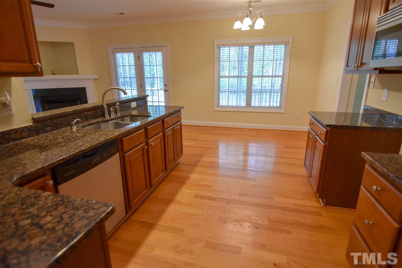292 Ned Moore Road Timberlake, NC 27583 - Photo 4 of 25 a kitchen with stainless steel appliances granite countertop a sink stove and cabinets