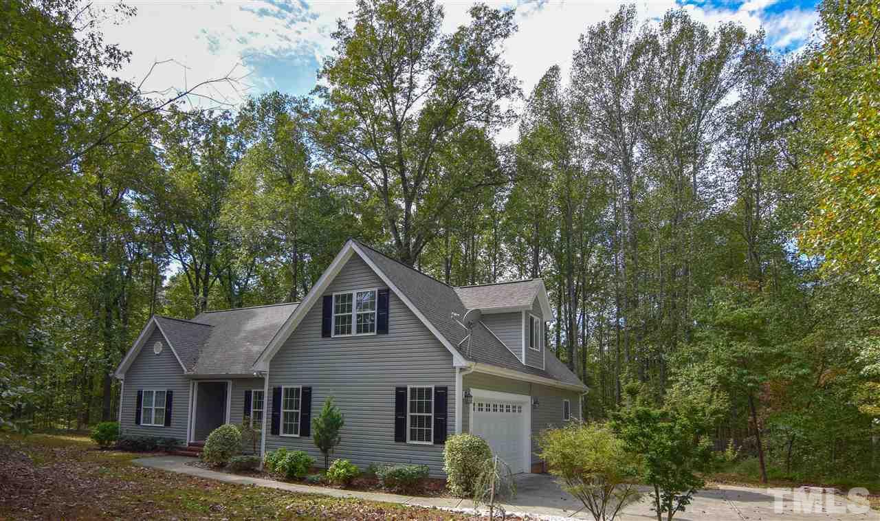 292 Ned Moore Road Timberlake, NC 27583 - Photo 6 of 25 a front view of a house with a yard and garage