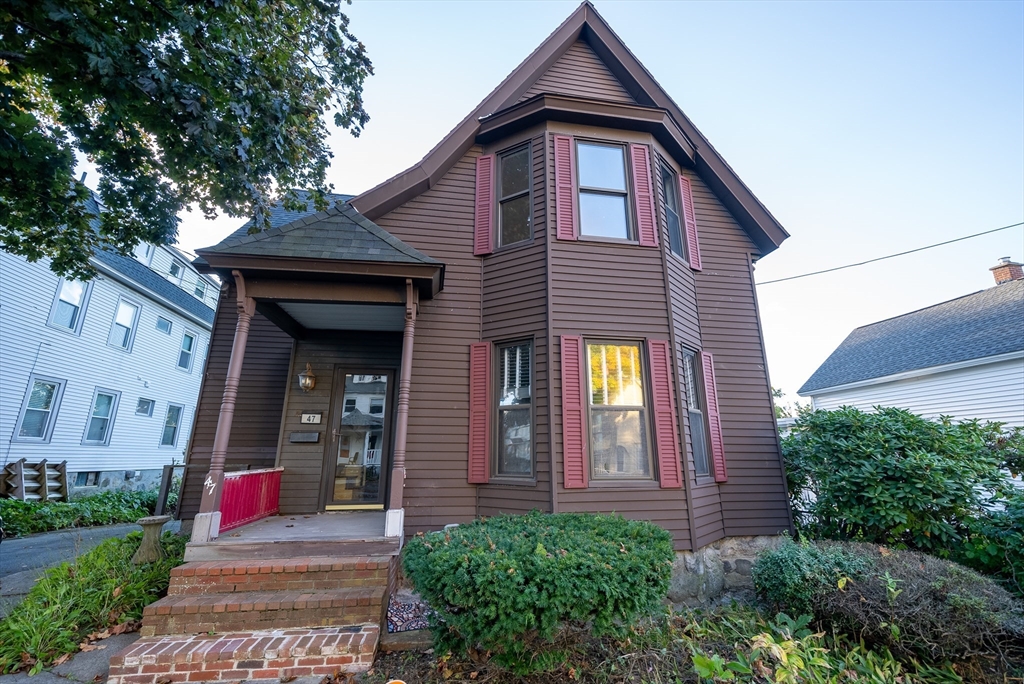 a front view of a house with large windows