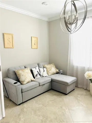 a living room with furniture and a mirror