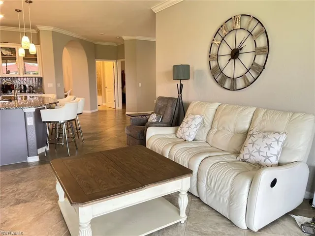 a living room with furniture a table and a painting