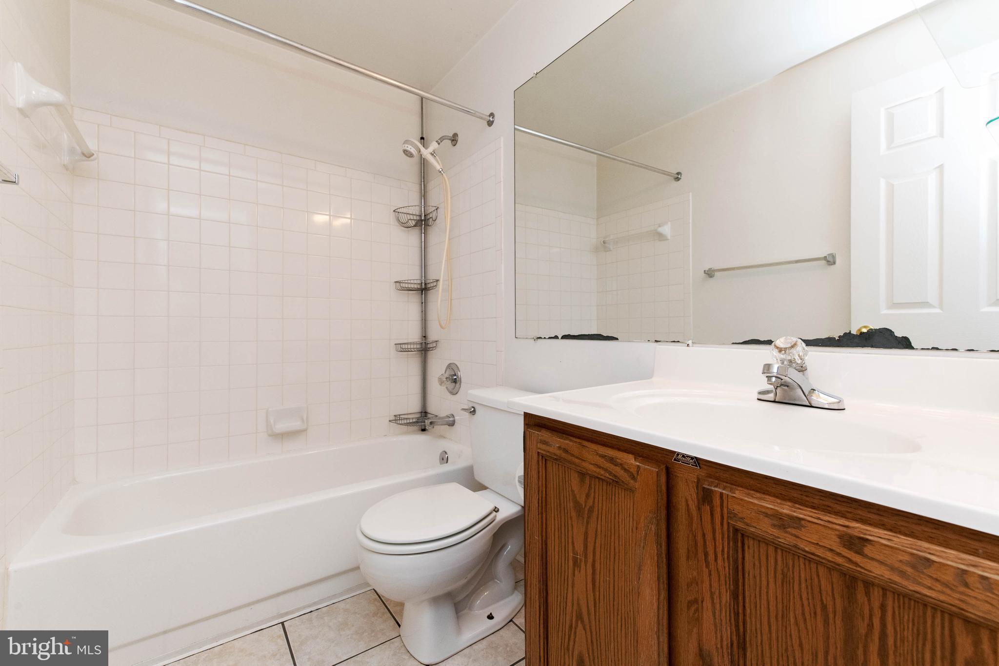 4403 Cole Farm Road Baltimore, MD 21236 - Photo 24 of 30 a bathroom with a sink a toilet and shower