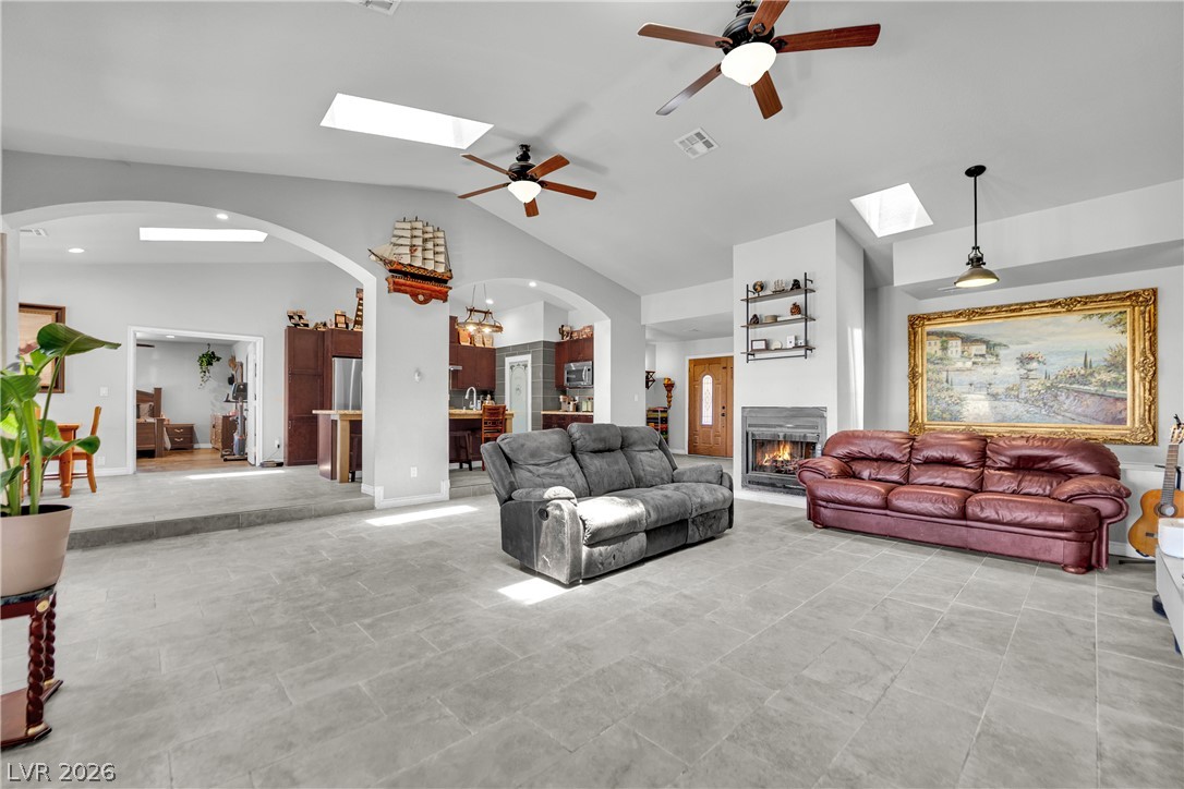 420 North Racetrack Road Henderson, NV 89015 - Photo 14 of 52 Natural light streams into this generously proportioned living area, featuring a cozy fireplace.