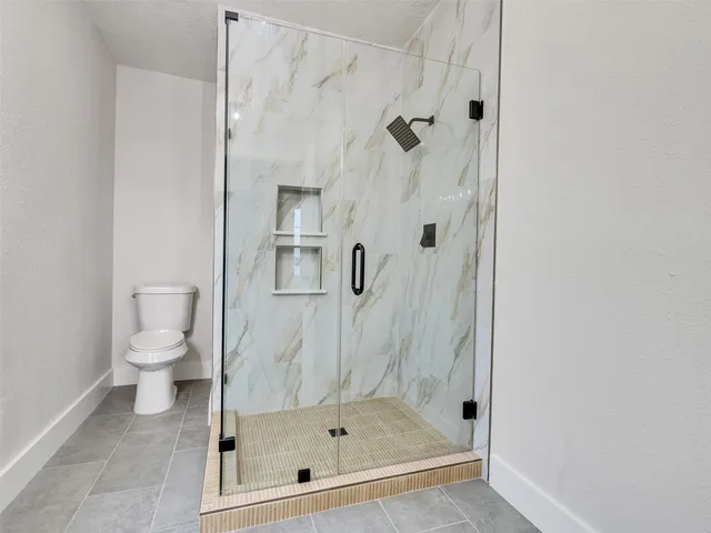 a bathroom with a glass shower door
