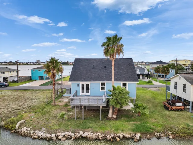 a view of house with garden space and car parked in the background