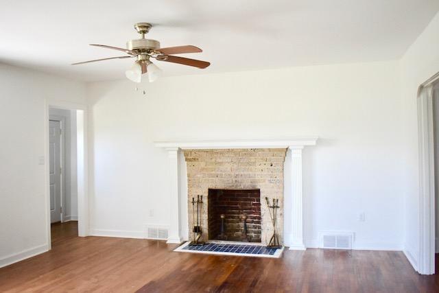 13753 West Gretna Road Sandy Level, VA 24161 - Photo 69 of 99 an empty room with wooden floor fireplace and windows