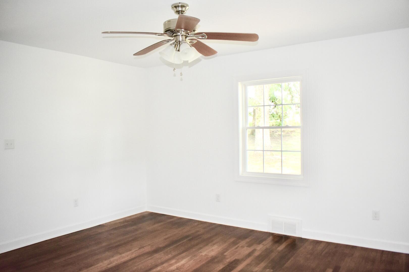 13753 West Gretna Road Sandy Level, VA 24161 - Photo 73 of 99 an empty room with wooden floor fan and windows