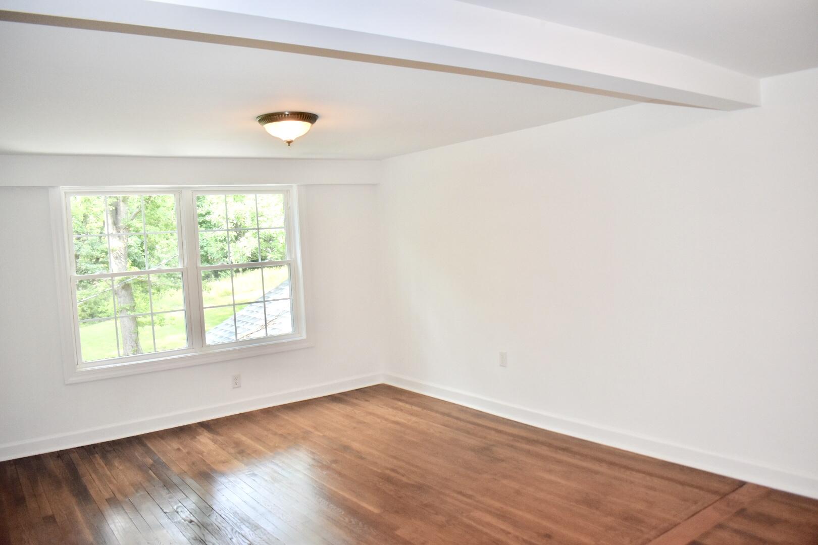 13753 West Gretna Road Sandy Level, VA 24161 - Photo 76 of 99 an empty room with wooden floor and windows