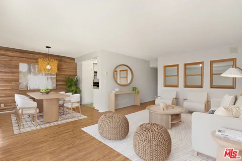 a living room with fireplace furniture and a large window