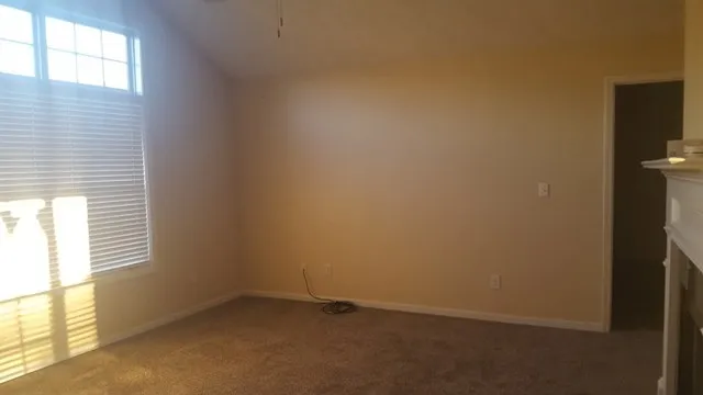 a view of an empty room and a window