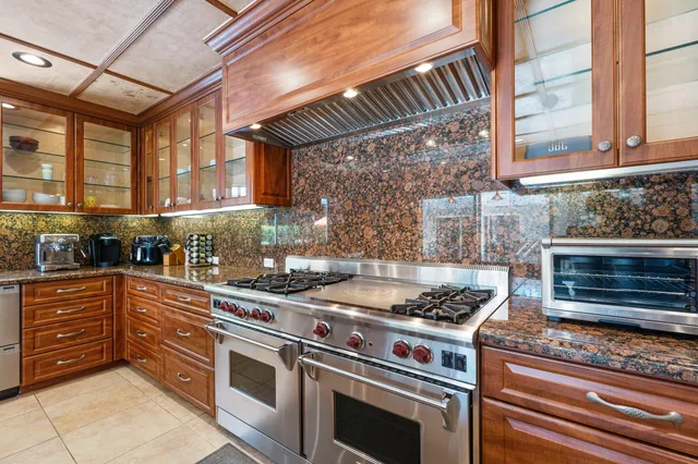 a kitchen with stainless steel appliances granite countertop a stove and a sink